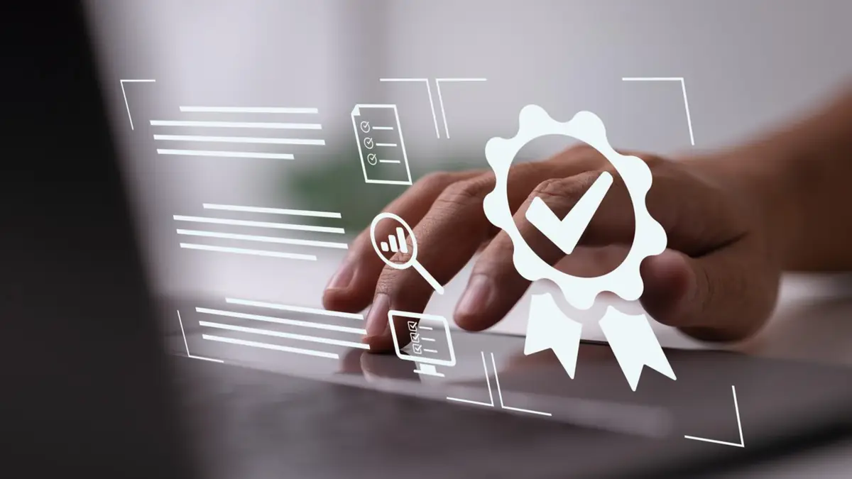 Close-up of hand typing on laptop with digital certification icons, symbolizing hurdles in the Microsoft Operator Connect Program.